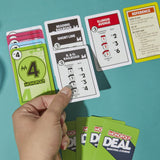 Monopoly game cards on a teal background with a hand holding a card.